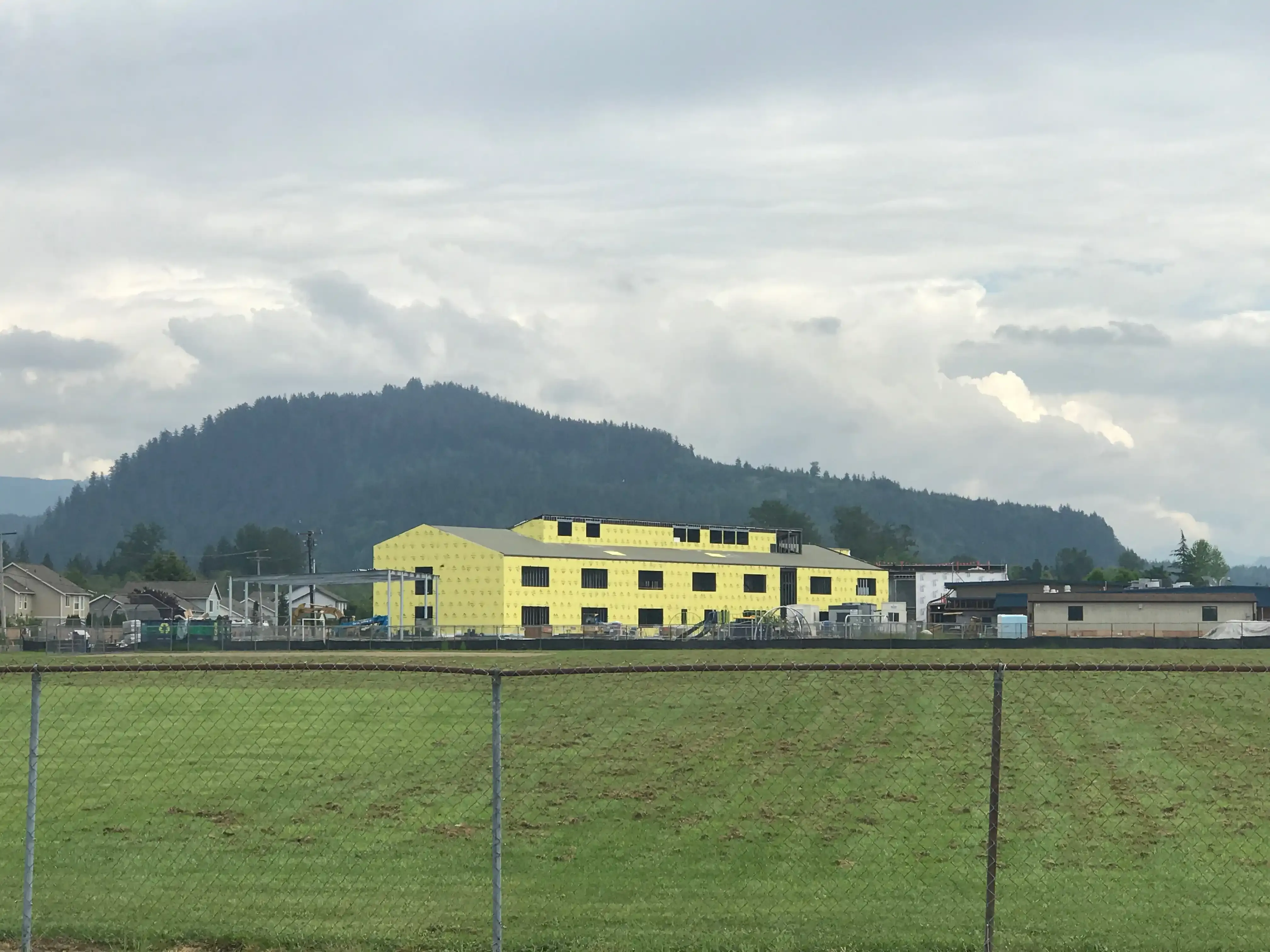 Photo of the building shell of 'B-wing' from across the large playfield of the school.