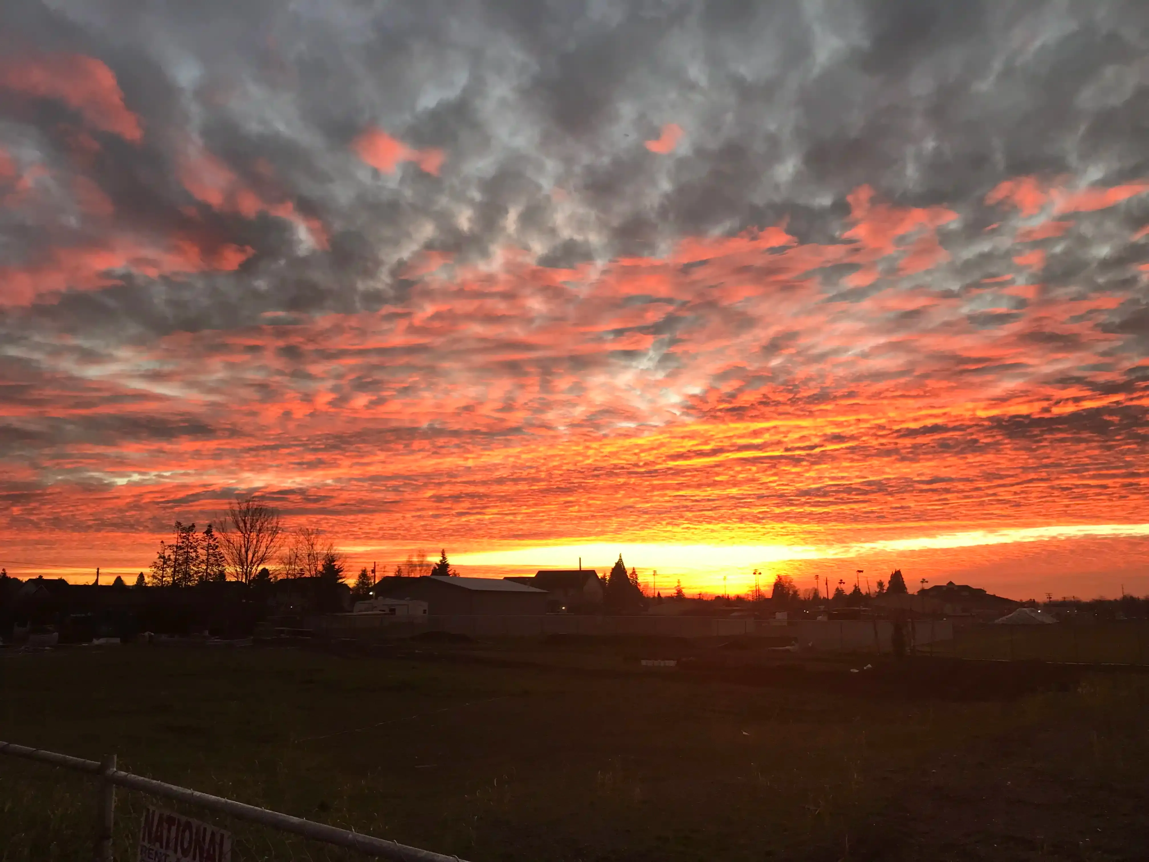 Photo of a pink-sky sunset looking west from the job-site one evening.