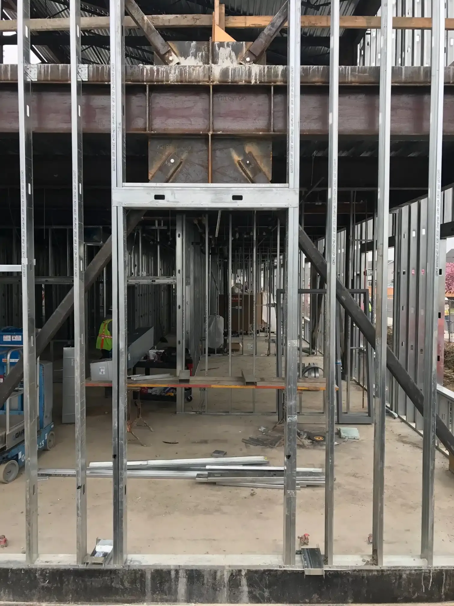 Photo of the same place at the building as the model image above but in real life, featuring the structure embedded within the metal-stud framing.