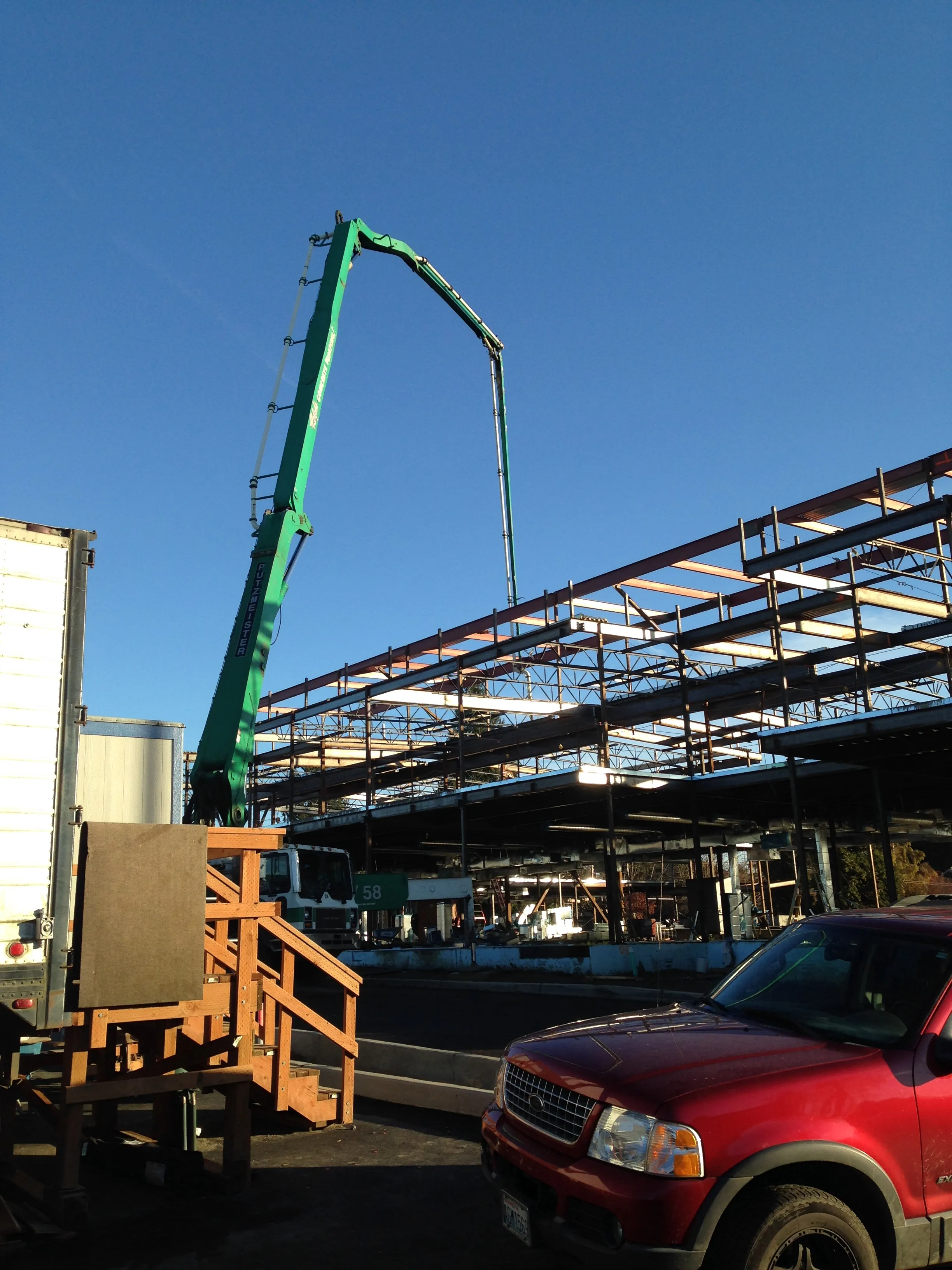 Photo of a concrete pump placing concrete on the second-level of 'B-Wing' of the new elementary school.