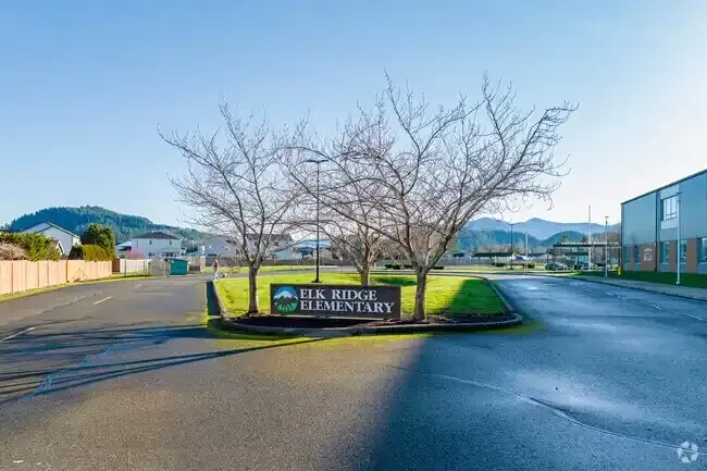 Photo of the school sign in the median of the busloop entrance that reads:'Elk Ridge Elementary'