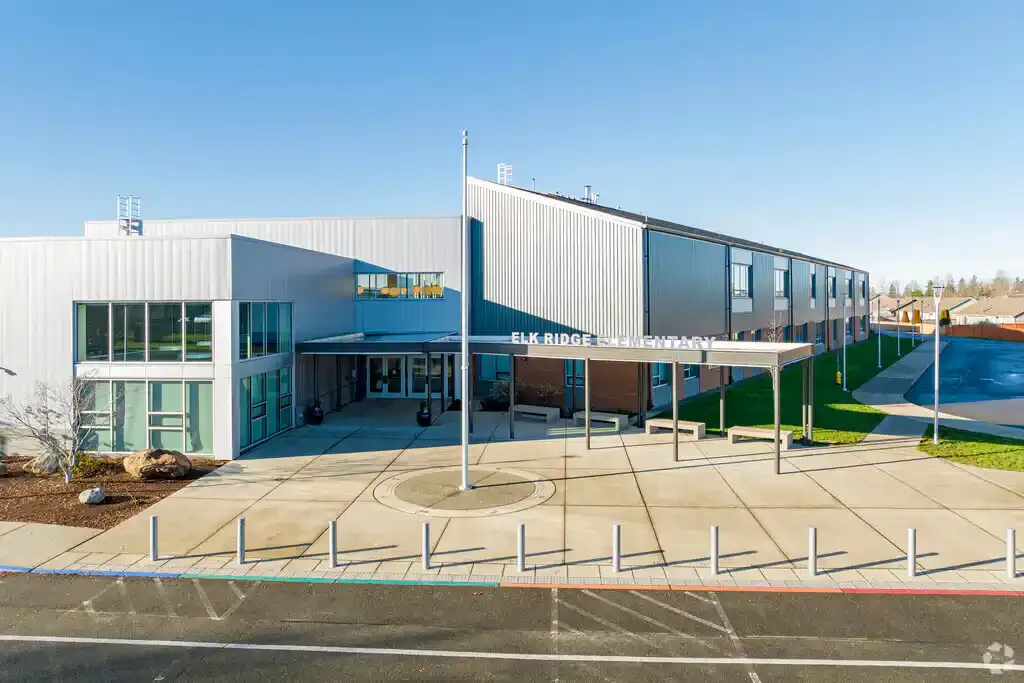 Photo of the new main entrance with raised metal sigange that reads,'Elk Ridge Elementary' above the canopy. 